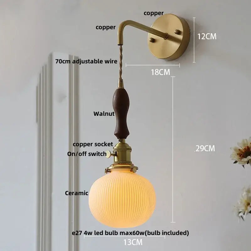 Vintage brass ceramic knob wall light with copper sconce, walnut handle, ribbed ceramic globe shade, and adjustable wire