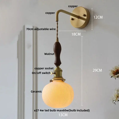Vintage brass ceramic knob wall light with copper sconce, walnut handle, ribbed ceramic globe shade, and adjustable wire