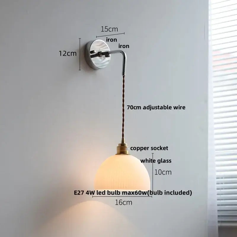A warm white glass wall lamp with polished brass socket and adjustable iron arm decorbites ceramic led wall sconce