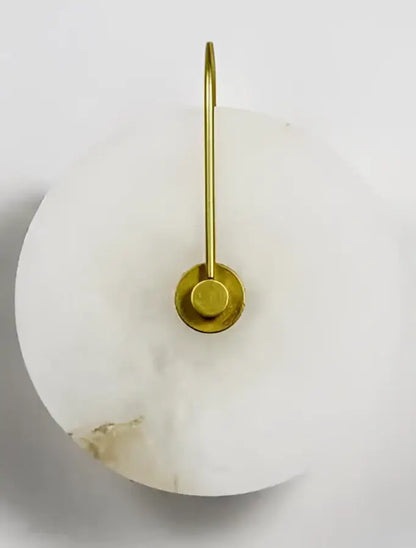 A sleek white marble wall lamp with polished brass base and knob switch decorbites ceramic wall sconce for bedroom