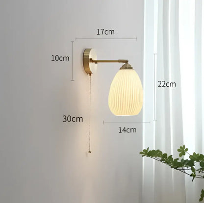Vintage brass ceramic wall lamp with ribbed warm-toned glass shade and pull-chain switch for bedroom decorbites ceramic wall lamp