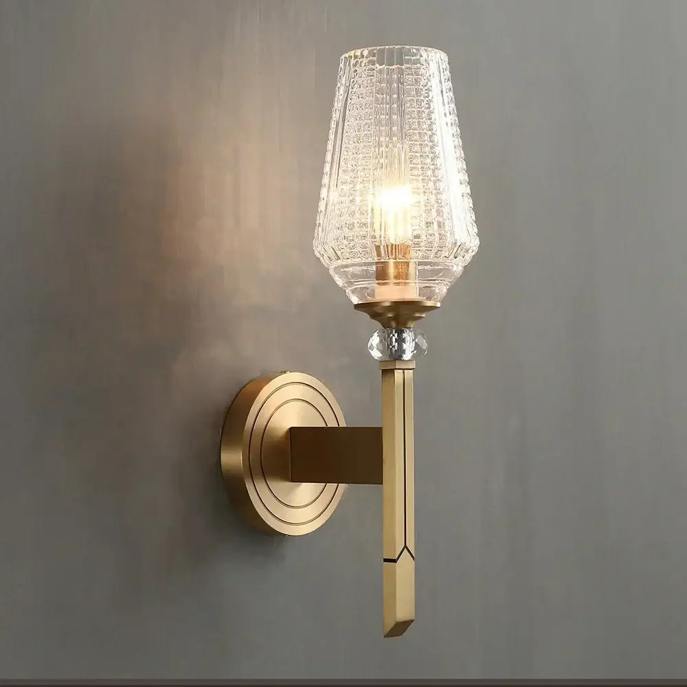 A brass-finished vintage wall lamp with clear textured glass shade and faceted crystal accent for bedroom decorbites crystal copper wall