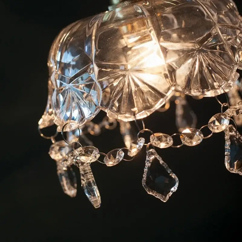 A clear faceted crystal glass led pendant light with teardrop and oval crystals for dining room decorbites decor