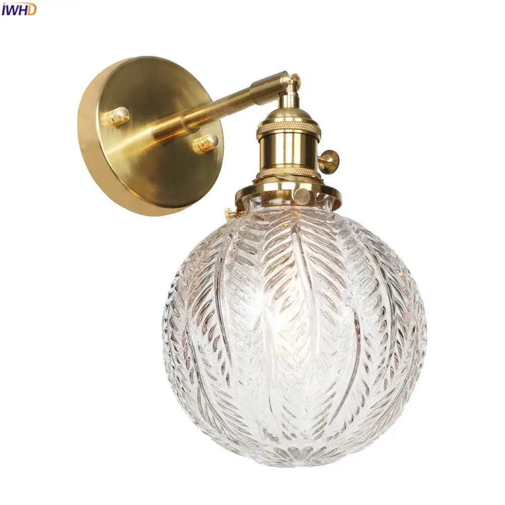 Vintage brass led wall light featuring an etched glass globe for bedroom use with intricate detailing