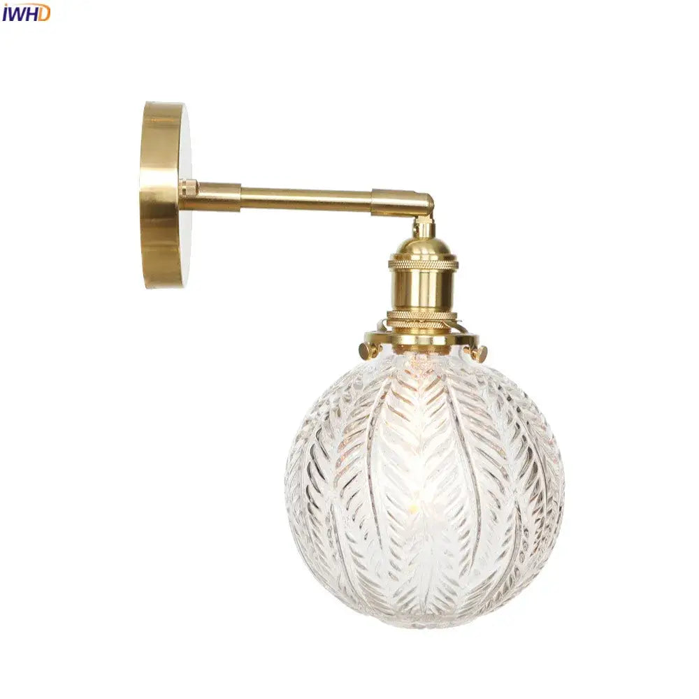 Vintage brass led wall light with an etched glass globe designed as a bedroom wall light sconce