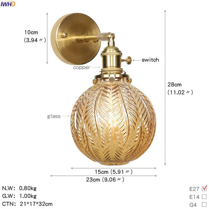 Vintage brass led wall light with textured golden glass globe and leaf-like etchings for bedroom sconce use