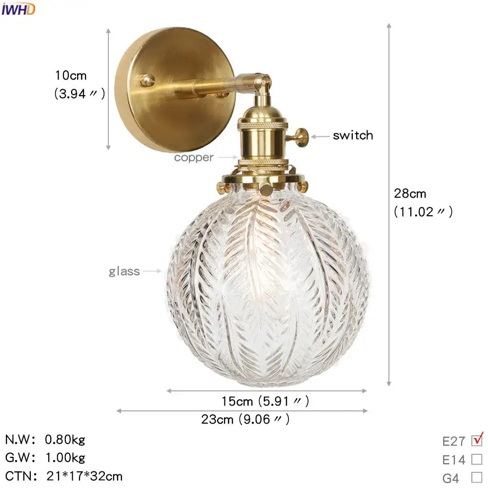 Vintage brass led wall light featuring a clear intricately etched glass globe for bedroom wall lighting