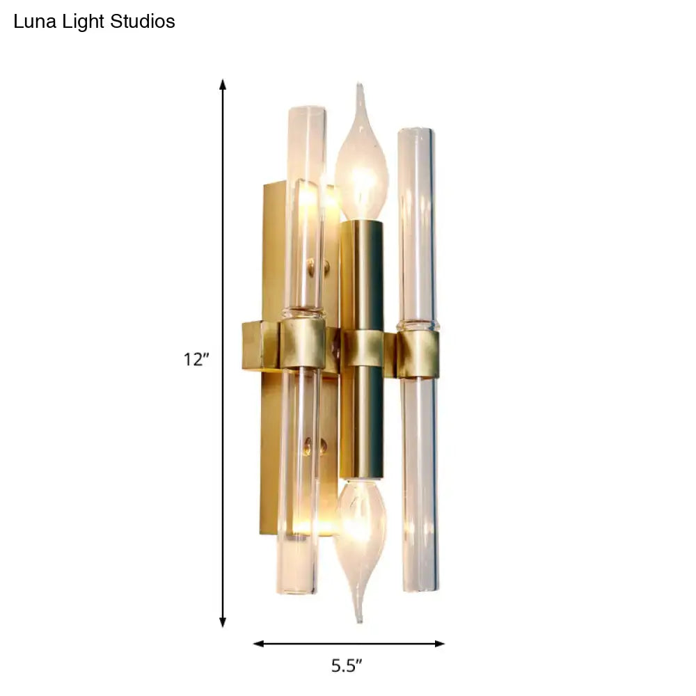Vintage brass finish candle wall sconce in gold tone with clear glass tubes and central cylindrical accent for living room decor