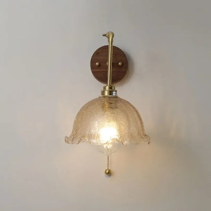 A warm-toned textured glass vintage brass led wall light with rotate pull chain for bedroom decorbites led wall
