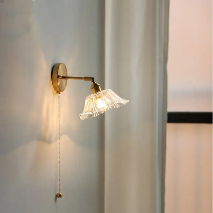 Vintage brass fluted glass bedside sconce wall light with gold-toned finish and elegant pull-chain switch decorbites glass bedside