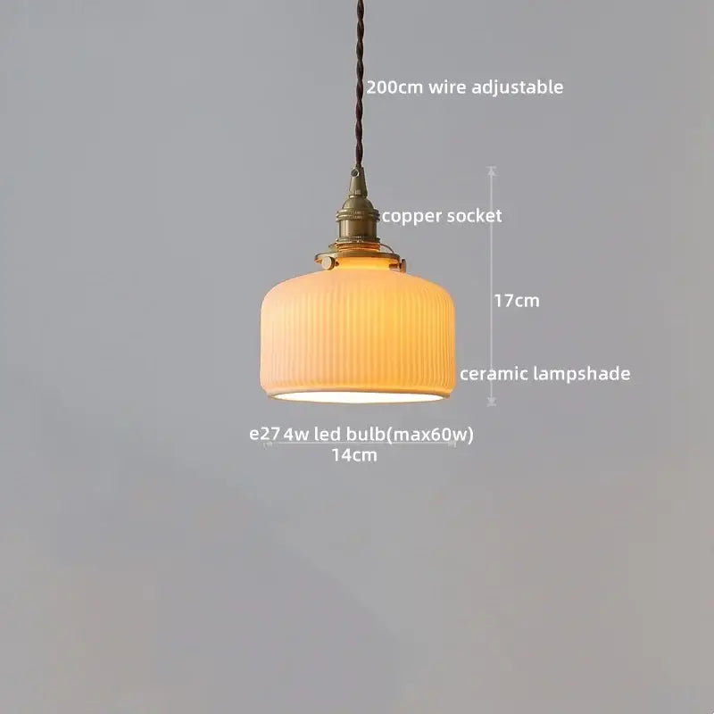 Warm-toned ceramic lampshade with vertical ridges in a vintage brass fluted glass led pendant for dining room lighting