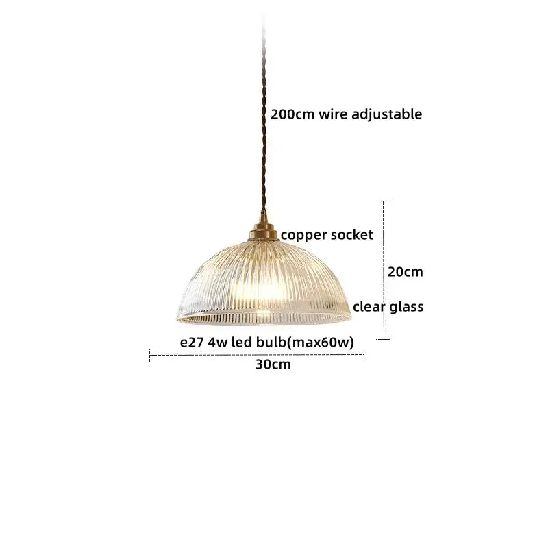 A clear glass led pendant with a ribbed dome shade and vintage brass copper socket for dining room use