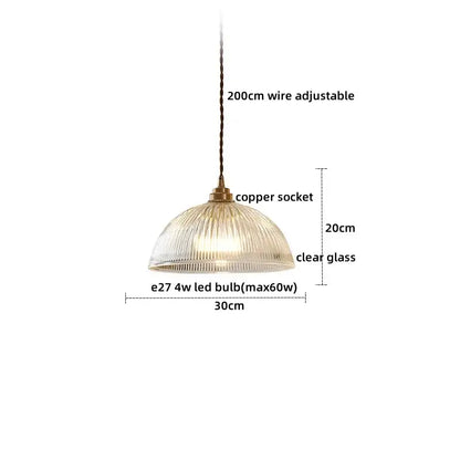 A clear glass led pendant with a ribbed dome shade and vintage brass copper socket for dining room use