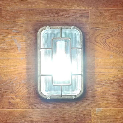 Vintage brass gas station canopy wall light with frosted glass panel and metallic frame for outdoor security