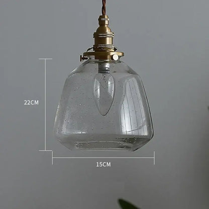 Clear glass led pendant light with vintage brass finish and exposed filament bulb for dining room use