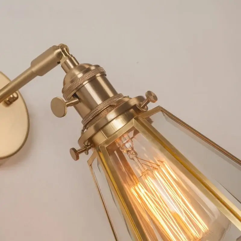Vintage brass glass led wall light featuring a brass-finished sconce with clear glass shade and exposed filament bulb