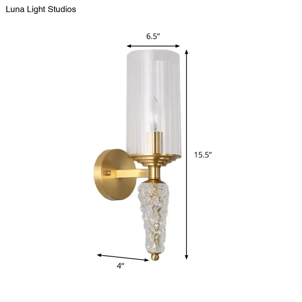 Vintage brass wall mounted lighting fixture with gold finish, clear textured glass base, and frosted glass shade