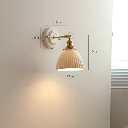 Cream-colored ribbed ceramic wall sconce with brass-finished metal arm and mounting plate for vintage decorbites copper arm led lighting