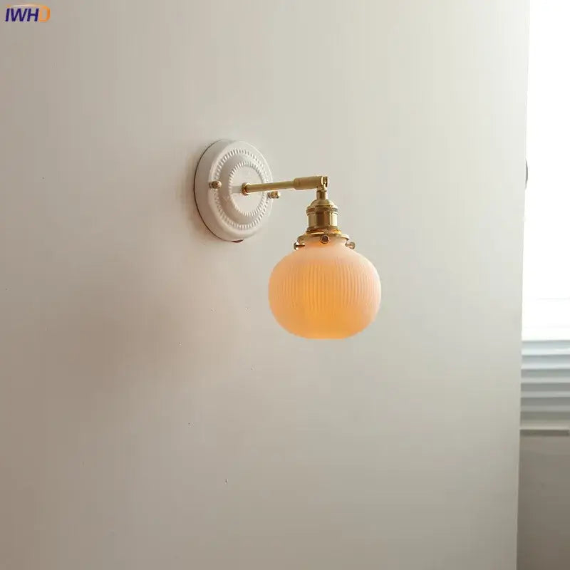 Vintage brass globe wall sconce with opalescent ribbed glass and brass-finished decorbites copper arm led fixture