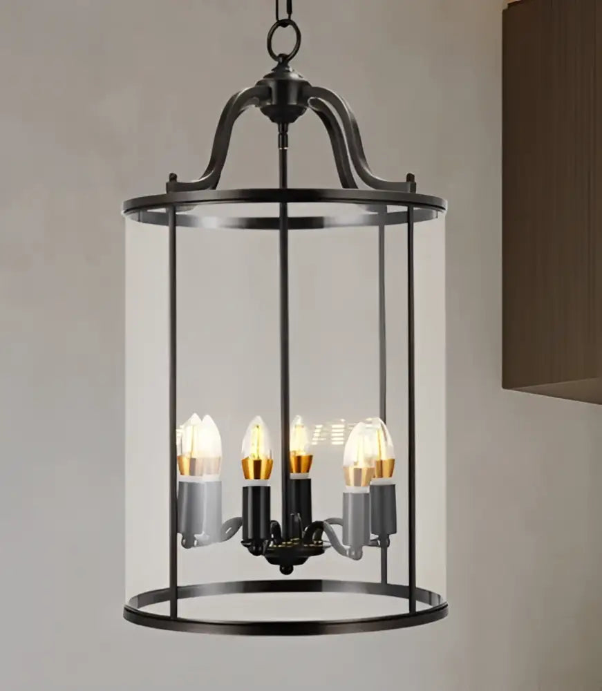 Vintage brass pendant light with black wrought iron frame and clear glass enclosure featuring led bulbs helps create ambiance
