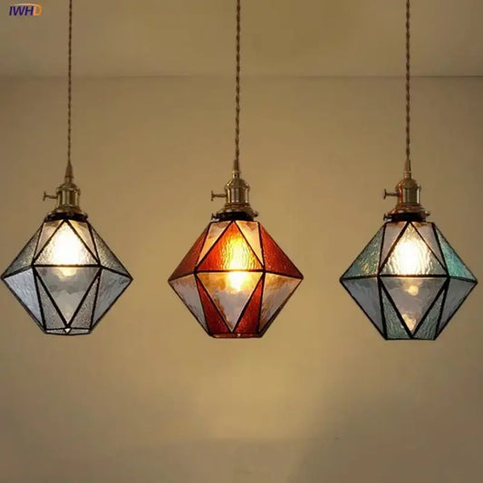 Three geometric brass vintage led pendant lights with clear amber and teal stained glass panels for dining room decorbites