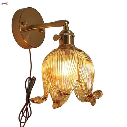 Golden brass wall light with ribbed loft amber glass shade shaped like an open flower for bedroom decorbites loft amber