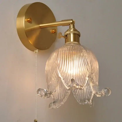 Gold-toned vintage brass loft amber glass wall light with clear ribbed flower-shaped shade for decorbites loft amber decor