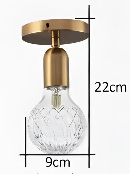 Vintage brass pendant lamp featuring a brass pendant with a faceted crystal bulb for dining room lighting