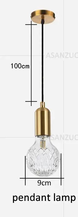 Vintage brass pendant lamp featuring a gold finish with a clear faceted glass bulb and black cord for dining room use