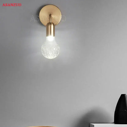 Gold-toned brass pendant lamp with clear faceted glass bulb designed for dining room lighting