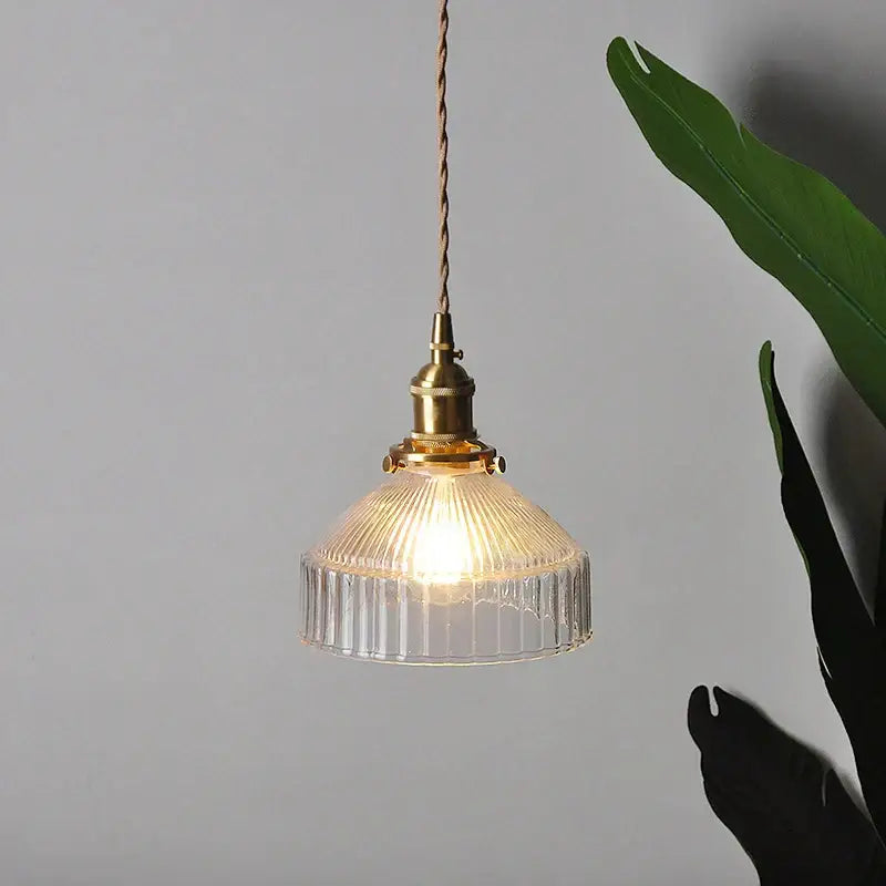 A warm-toned vintage brass ribbed glass led ceiling chandelier with clear glass shade for bedroom lighting