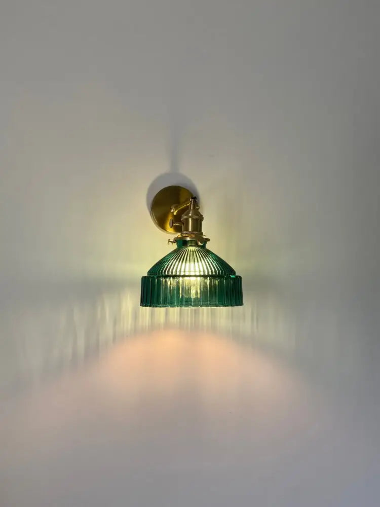 Vintage brass wall sconce with green ribbed glass shade and brass hardware for bedroom wall lamp lighting