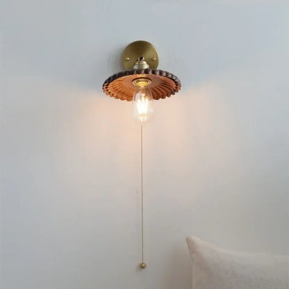 Vintage brass scalloped amber glass wall lamp with petal-like shade and exposed filament bulb light fixture for bedroom