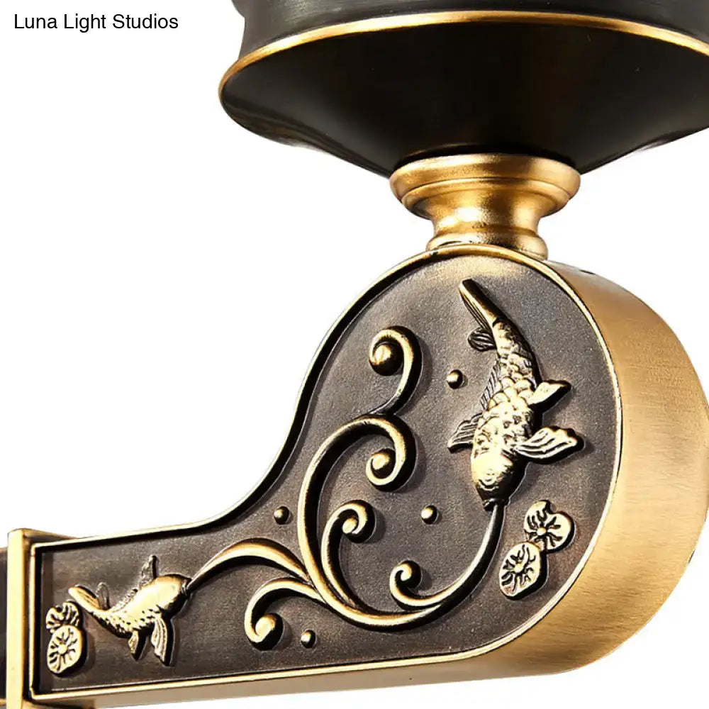 Vintage brass sconce with clear textured glass features an antique brass finish with embossed koi fish and aquatic motifs