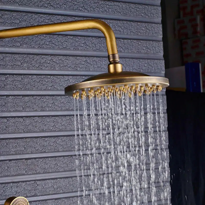 Vintage brass shower faucet mixer set featuring a round rainfall shower head with multiple water jets in brass finish