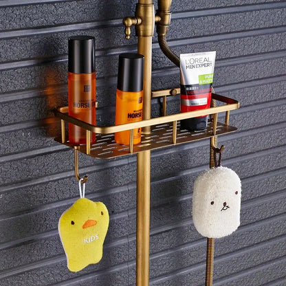 Vintage brass shower faucet mixer set featuring a slotted tray and hooks holding bath products for bathroom use