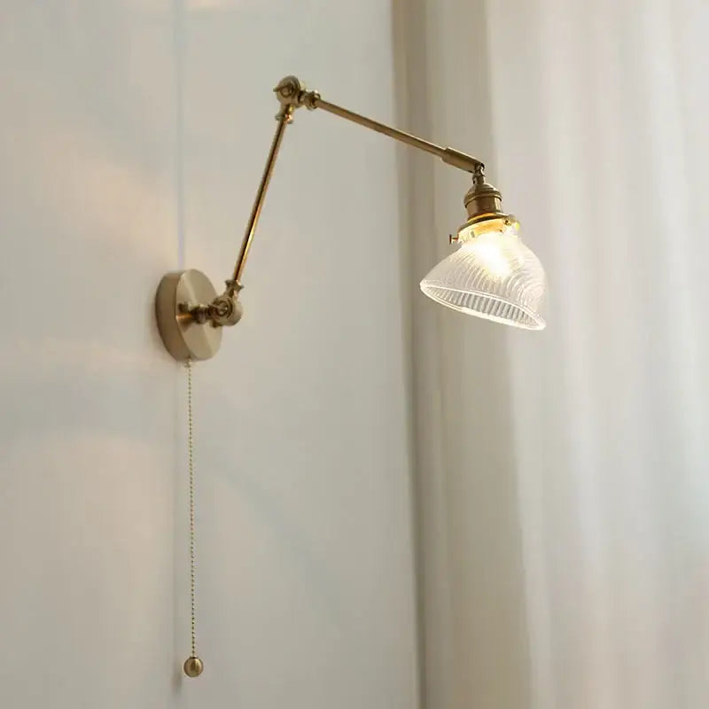 Antique brass adjustable vintage wall light fixture with ribbed glass shade and pull-chain switch for bedroom use