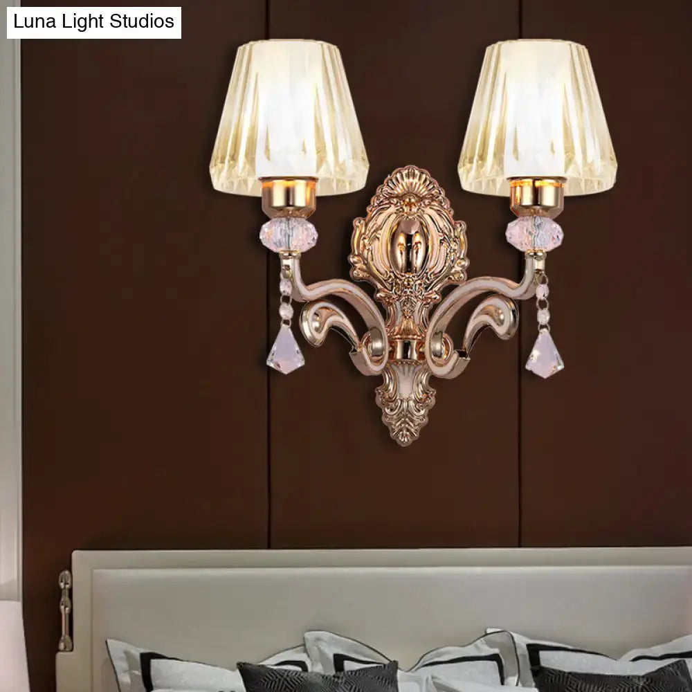 Ornate vintage brass wall lamp with clear glass shade featuring two fluted cream glass shades and crystal accents
