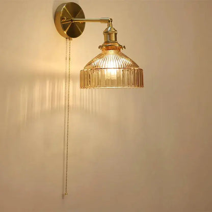 Vintage brass wall lamp with gold-toned adjustable arm and ribbed translucent glass shade led for living room use