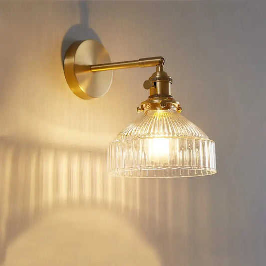 Vintage brass wall lamp featuring a ribbed glass shade designed for elegant living room lighting with glass shade led option
