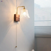 Vintage brass wall light with clear glass ornate shade featuring floral etchings for bedroom decorbites clear glass
