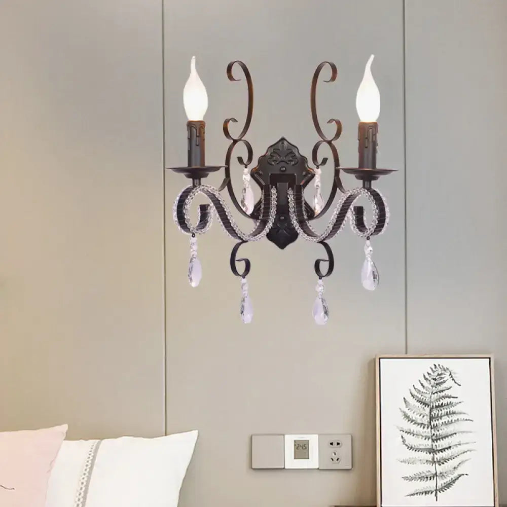 Vintage bronze wall mounted lamp in antique wrought iron with crystal droplets and candle style bulbs for living room use