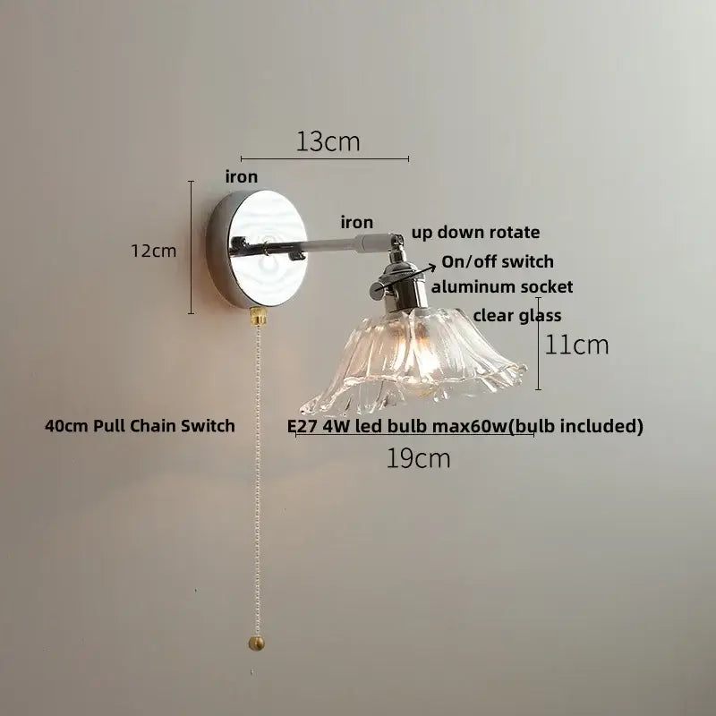 Vintage brushed nickel led wall light with polished iron arm and clear glass petal-shaped shade for bedroom use