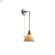 Vintage ceramic led wall sconce with cream ribbed glass shade and brass accents for elegant bedroom decorbites ceramic led lighting