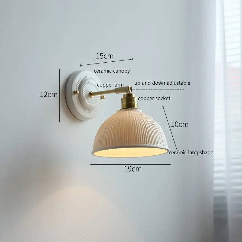 Cream-colored ceramic wall lamp with ribbed texture mounted on brass copper arm for bedroom decorbites ceramic wall lamp