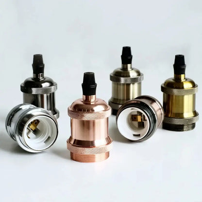 A vintage copper chrome e27 lamp base lampholder in brushed brass copper and blackened steel with textured knurled bands