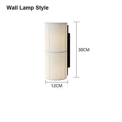 A sleek cylindrical vintage cream fabric hashira cluster pendant light with soft shade and black metal bracket for dining room decor