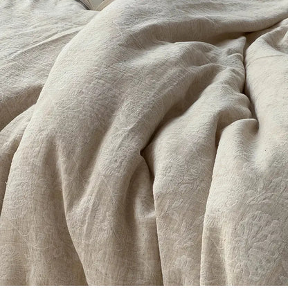 Beige linen duvet cover with subtle floral embroidery in vintage cream bedding set with jacquard lace ruffles