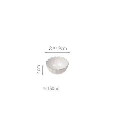 A delicate white ceramic bowl with a fluted scalloped rim for a vintage cream scalloped ceramic dining table set