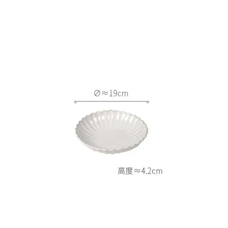 Vintage cream scalloped ceramic dish with subtle ridged texture from a dining table set for elegant dining room trim